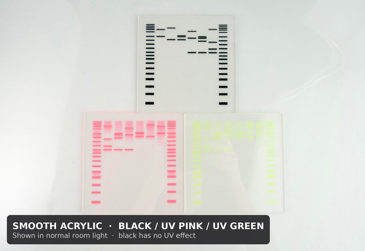 Three smooth acrylic DNA gel coasters in black, UV pink and UV green, shown in normal room light