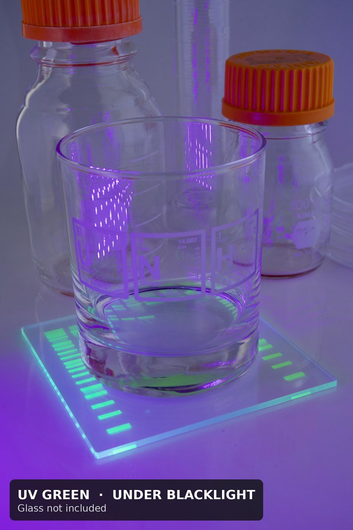 UV green DNA gel coaster glowing under blacklight with a glass on top and lab bottles behind (glass not included)